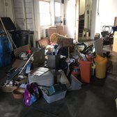 Garage full of unwanted items, furniture, recycling, and garbage. Customer was ready for our residential junk pickup and removal services.