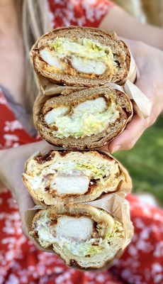 Photo of Grubbin' - San Francisco, CA, US.  a woman holding a stack of sandwiches