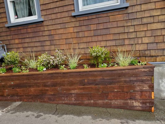 Photo of SF Gardening Services - San Francisco, CA, US. a wooden planter on the side of a house