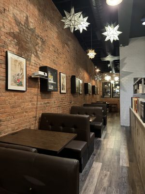 Photo of Tekkaba - Vancouver, BC, CA. a row of tables and booths in a restaurant