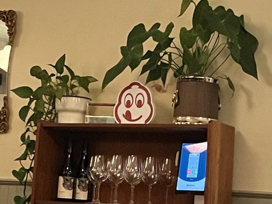 Photo of Say Mercy - Vancouver, BC, CA. a wooden shelf with wine glasses and a potted plant