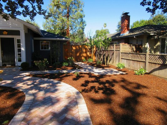 Photo of RB landscaping - Redwood City, CA, US. Renovated backyard complete with new stone path.