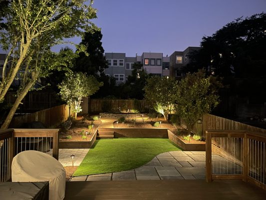 Photo of Logiculture - San Francisco, CA, US. Soft glow of landscape lighting at night in this newly reimagined Richmond backyard