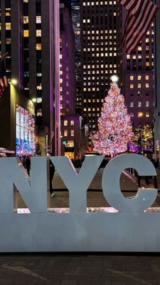 Photo of Rockefeller Center - New York, NY, US. We  NYC sign. Christmas tree view