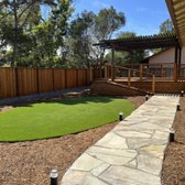 New bluestone walkway, turf & lighting & redwood fence.