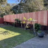 Redwood fence standard nail on with retaining wall



