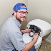Plumber James working on a toilet repair