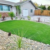 Low maintenance front yard landscape. 
Artificial turf with tropical plants, and a stamped driveway!