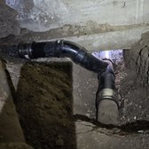 Replace sewer pipe under house foundation.