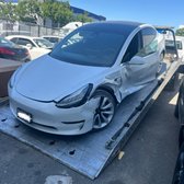 Secondary tow. Tesla being transported to a collision center post accident