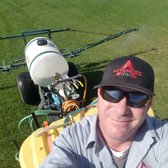 Service technician during a broadleaf weed control and fertilizing service.