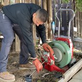 Mike Clearing a sewer drain 