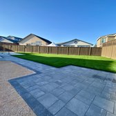 Installation of paver walkway leading to side of yard and firepit area. 