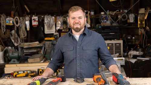 Portrait of Nathan Gilbert with oscillating multitools.