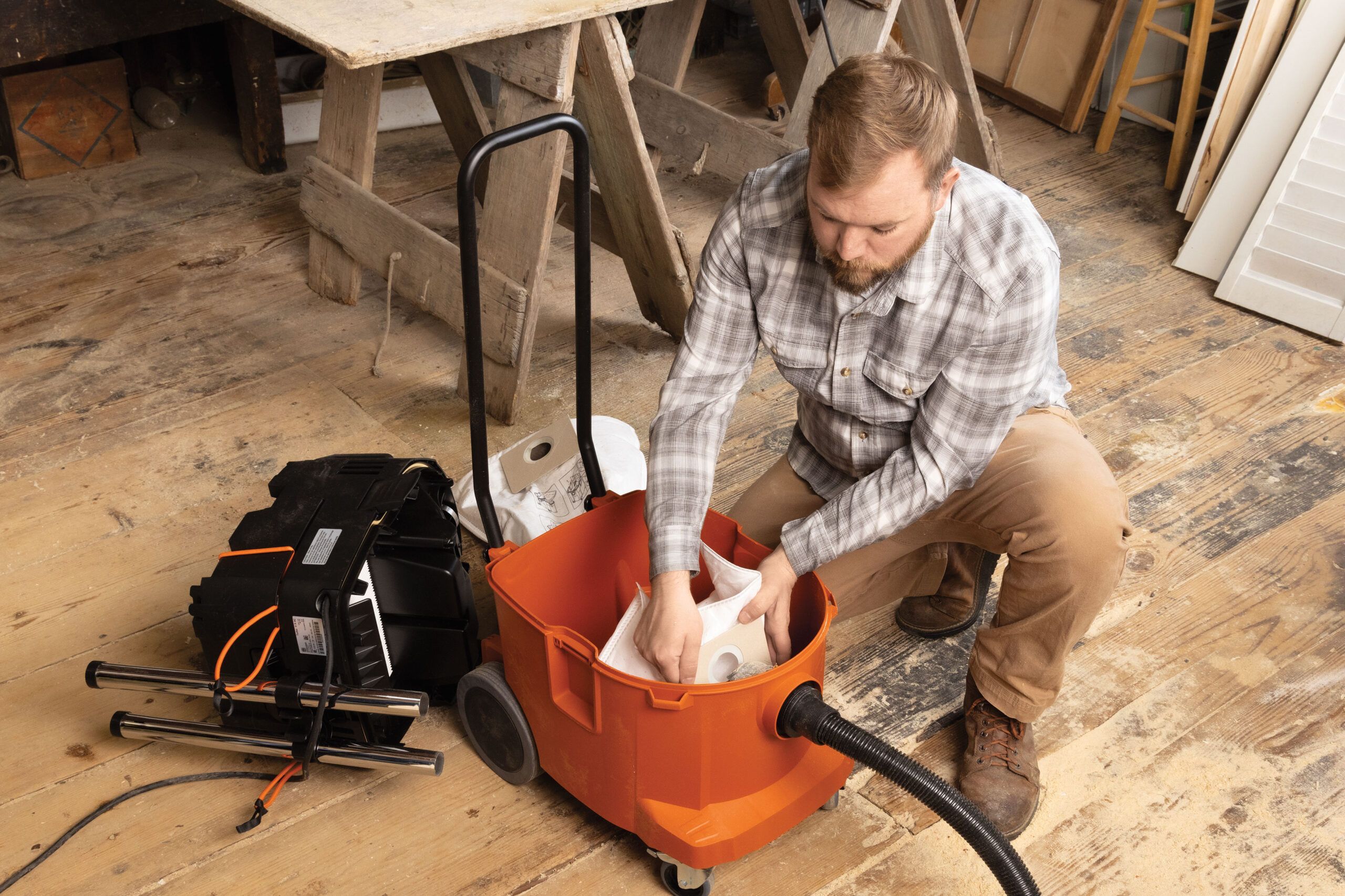 Nathan Gilbert changing the filter on a shop vac