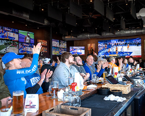 Kentucky Basketball fans cheering at Double Dogs Lexington.