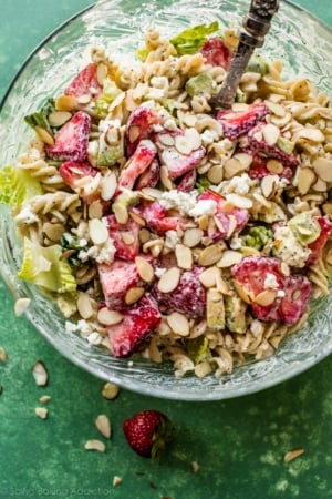 strawberry feta pasta salad in a glass bowl