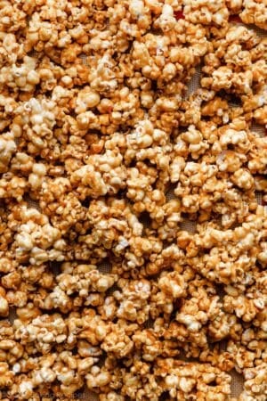 caramel corn spread on lined baking sheet.