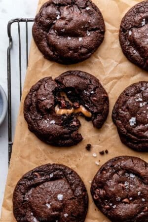 salted caramel dark chocolate cookies on brown parchment paper.