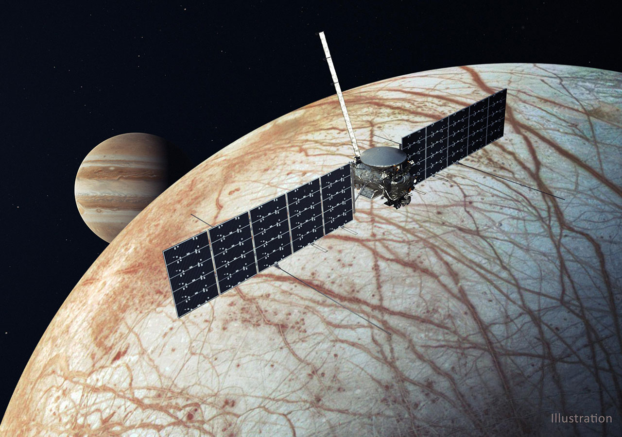 An illustration of Europa Clipper flying past Europa with Jupiter behind the moon, and the spacecraft.