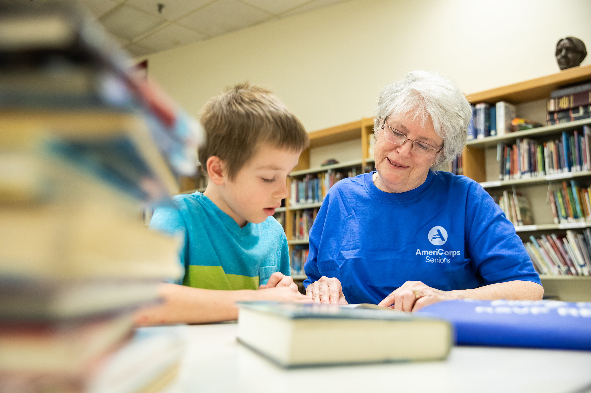 child reading with AmeriCorps Seniors member