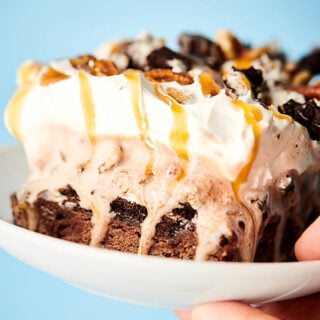 Holding caramel fudge brownie ice cream cake