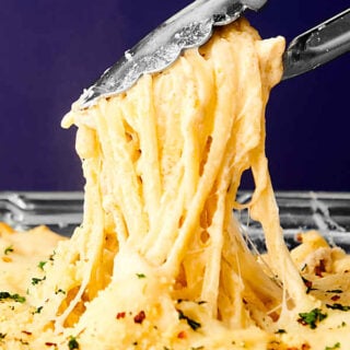 chicken tetrazzini being served with tongs