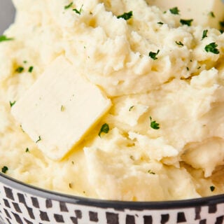 holding a bowl of mashed potatoes with boursin cheese