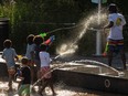 Children play with water guns at a splash pad at LeFrak Center at Lakeside at Prospect Park in Brooklyn, New York.