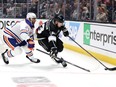 LOS ANGELES, CALIFORNIA - APRIL 26: Viktor Arvidsson #33 of the Los Angeles Kings controls the puck past the defense of Darnell Nurse #25 of the Edmonton Oilers during the second period of Game Three of the First Round of the 2024 Stanley Cup Playoffs at Crypto.com Arena on April 26, 2024 in Los Angeles, California.