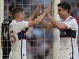 Vancouver Whitecaps forward Brian White (24) celebrates with midfielder Ryan Gauld (25) after scoring a goal during MLS match against Minnesota United in St. Paul, Minn., Wednesday, July 3, 2024.