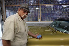 Fred Bottcher using a clay bar on his customized 1957 Cadillac