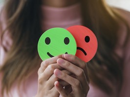 Woman Hands holding sad face hiding or behind happy smiley face, bipolar and depression, mental health concept, personality, mood change, therapy healing split concept.