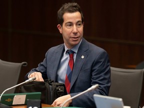 A man in a suit is sitting at a desk.