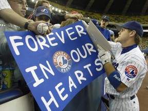 Montreal Expos first baseman Brad Wilkerson signs autographs before the team's final home game in Montreal Wednesday, Sept. 29, 2004. Streaming service Netflix announced Wednesday that a new documentary about the MLB's Expos and their departure from Montreal will be coming to the platform.