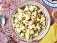 A bowl of potato salad on a pink tablecloth