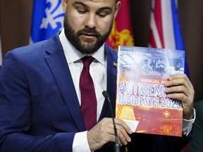 Richard Robertson, B'nai Brith Canada Director of Research and Advocacy, holds up an Annual Audit of Antisemitic Incidents in Canada during a press conference in Ottawa on Monday, May 6, 2024. B'nai Brith Canada flagged the issue of AI-generated hate content in a recent report on antisemitism.