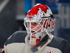 Elaine Chuli wears a goalie mask with a maple leaf design and '6IX' on the side