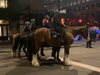 Riot police on horses at night