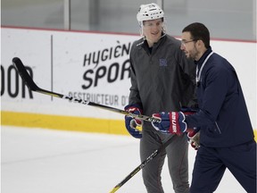 A coach and a player on the ice