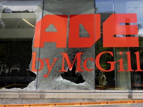 A broken window pane on McGill's engineering building with the university's name visible on the adjoining panes