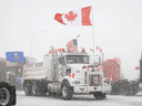 Anti-vaccine mandate protesters gather as a truck convoy blocks the highway the busy U.S. border crossing in Coutts, Alberta., Jan. 31, 2022.