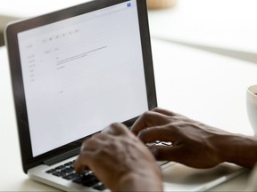 Person typing at a laptop keyboard