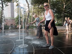 People keep cool in a fountain in Battery Park