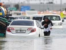 A driver walks through high water after abandoning his vehicle following a rainstorm in Dubai, United Arab Emirates, on Wednesday, April 17, 2024. The United Arab Emirates experienced its heaviest downpour since records began in 1949, Dubai's media office said in a statement.