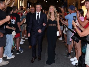 Rory McIlroy and wife Erica Stoll walk through fans at the Spanish Steps prior to the 2023 Ryder Cup at Marco Simone Golf Club.