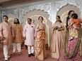 Billionaire Mukesh Ambani, third left, stands with his family members from left to right, son Akash, son Anant, wife Nita, daughter Isha and daughter-in-law Shloka at the wedding of his son Anant Ambani and Radhika Merchant at Jio World Convention Centre in Mumbai, India, Friday, July 12, 2024.