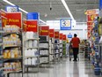 The Bank of Canada says business and consumer sentiment remained subdued during the second quarter of the year as the country prepared for an interest rate cut and watched inflation fall. People shop at a Walmart in Vaughan, Ont., on Wednesday, July 2, 2024.