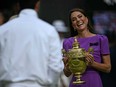 Kate, Princess of Wales prepares to give the winner's trophy to Spain's Carlos Alcaraz following his victory against Serbia's Novak Djokovic during their men's singles final tennis match on the fourteenth day of the 2024 Wimbledon Championships at The All England Lawn Tennis and Croquet Club in Wimbledon, southwest London, on July 14, 2024.