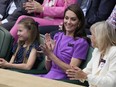 Kate, Princess of Wales, center, and her daughter Princess Charlotte, left, watch the men's singles final between Carlos Alcaraz of Spain and Novak Djokovic of Serbia, from the Royal Box at the Wimbledon tennis championships in London, Sunday, July 14, 2024.